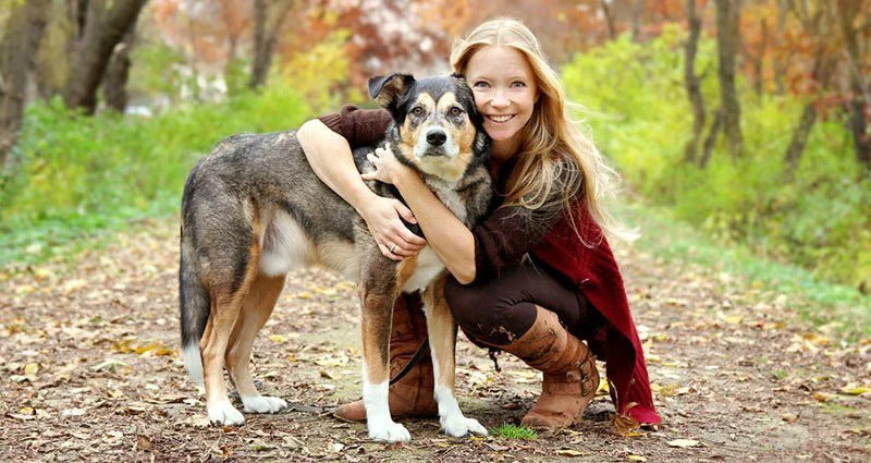 Woman and her dog looking at the camera.